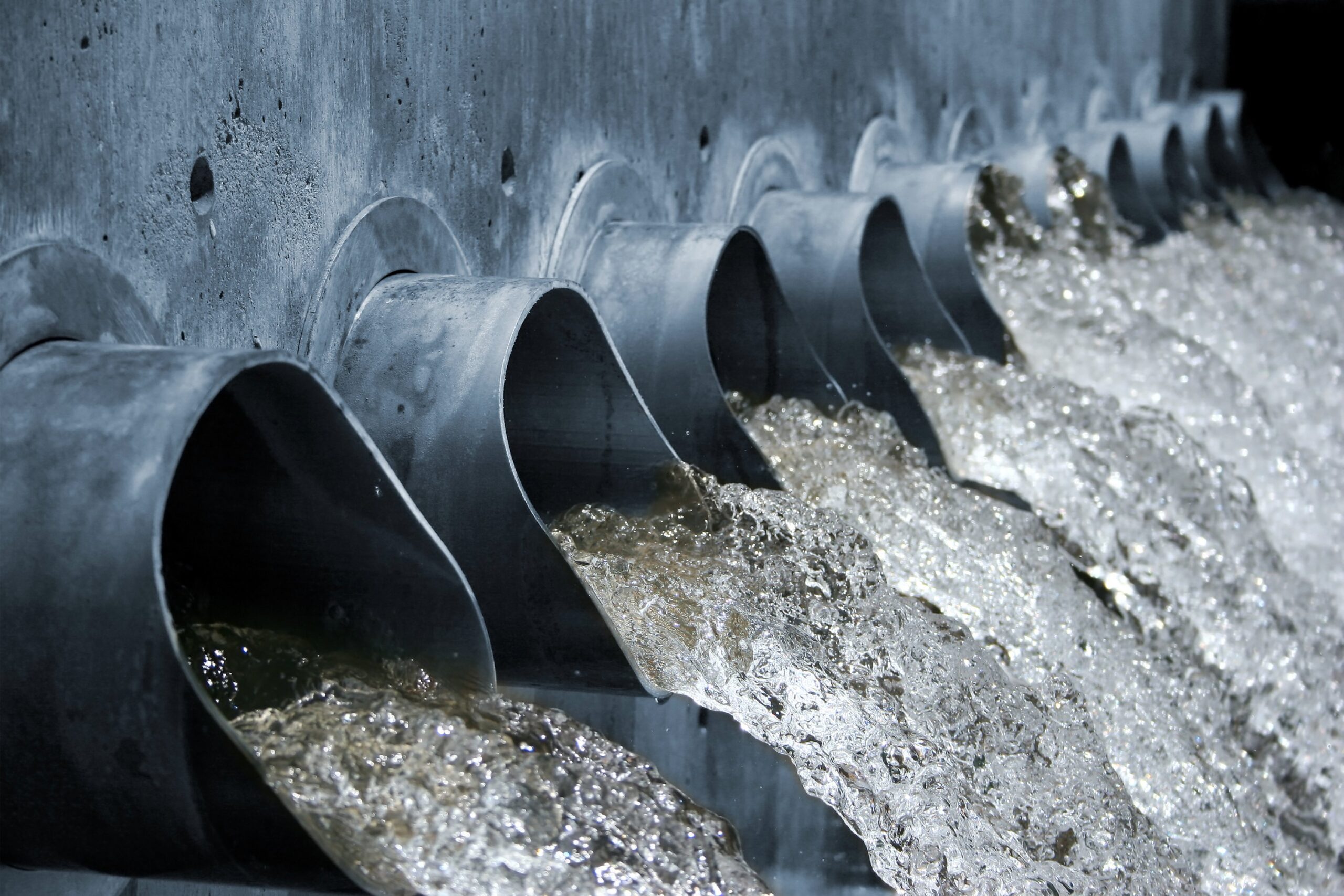 Effluent discharge pipes in a wastewater treatment system actively spewing water